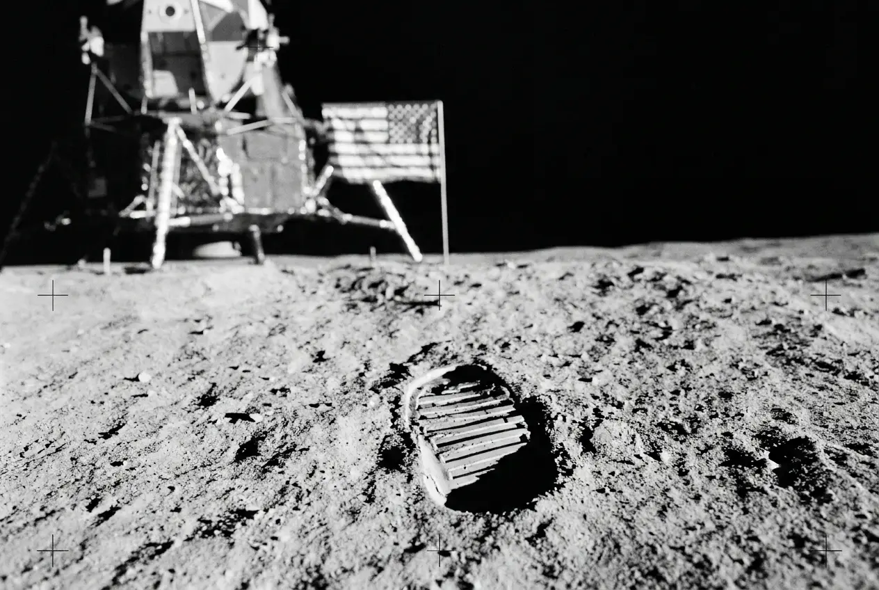 Reconstruction of the flag on its horizontal rod beside a sharp bootprint in lunar regolith